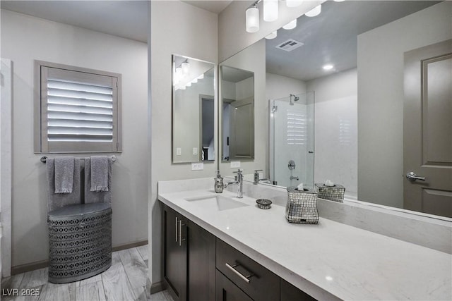 8175 Caldera Creek St, Las Vegas, NV 89113 - bathroom featuring a stall shower, vanity, and marble look tile flooring