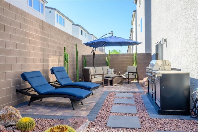 8175 Caldera Creek St, Las Vegas, NV 89113 - fenced backyard with a patio area, an outdoor hangout area, and grilling area