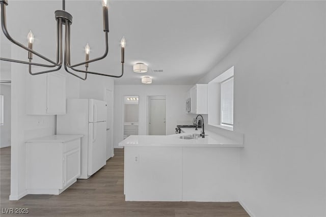3741 Cactus Wheel Ct, Las Vegas, NV 89129 - kitchen with freestanding refrigerator, white cabinetry, a chandelier, and dark wood-style floors