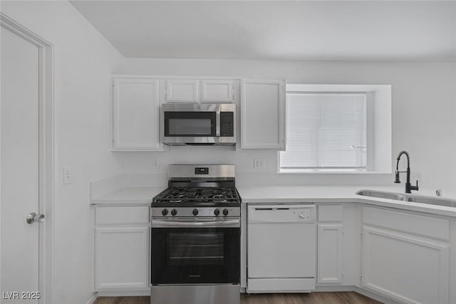 3741 Cactus Wheel Ct, Las Vegas, NV 89129 - kitchen featuring stainless steel appliances, white cabinetry, light countertops, and wood finished floors
