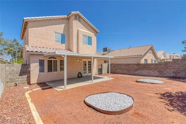 3741 Cactus Wheel Ct, Las Vegas, NV 89129 - rear view of property with stucco siding, a fenced backyard, french doors, and a patio