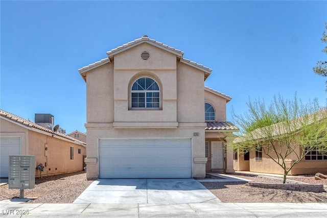 3741 Cactus Wheel Ct, Las Vegas, NV 89129 - mediterranean / spanish house featuring driveway, an attached garage, a tile roof, and stucco siding