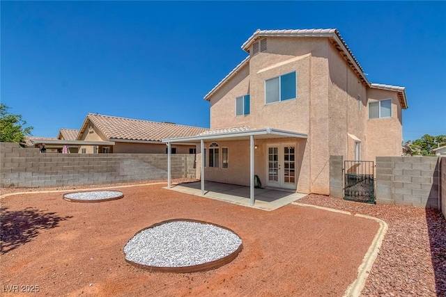 3741 Cactus Wheel Ct, Las Vegas, NV 89129 - rear view of property with stucco siding, french doors, a patio, and a fenced backyard