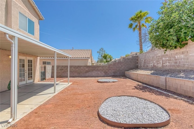 3741 Cactus Wheel Ct, Las Vegas, NV 89129 - fenced backyard with french doors and a patio