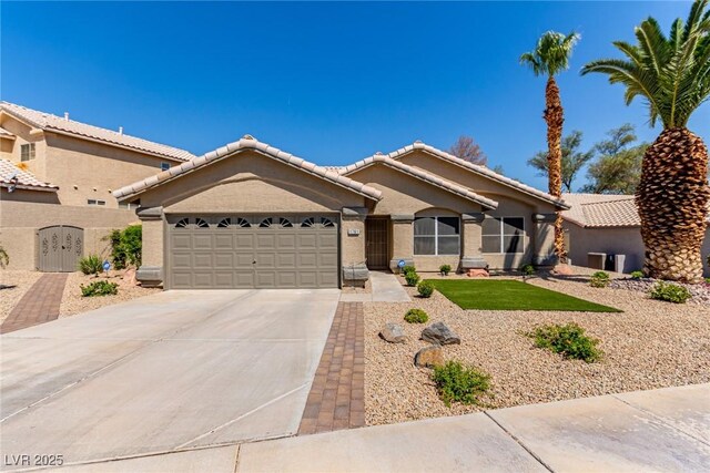 1761 Summerwood Cir, Henderson, NV 89012 - view of front facade with an attached garage, concrete driveway, stucco siding, and a tiled roof