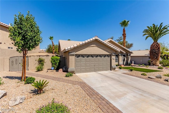 1761 Summerwood Cir, Henderson, NV 89012 - ranch-style house with a garage, driveway, stucco siding, and a tiled roof