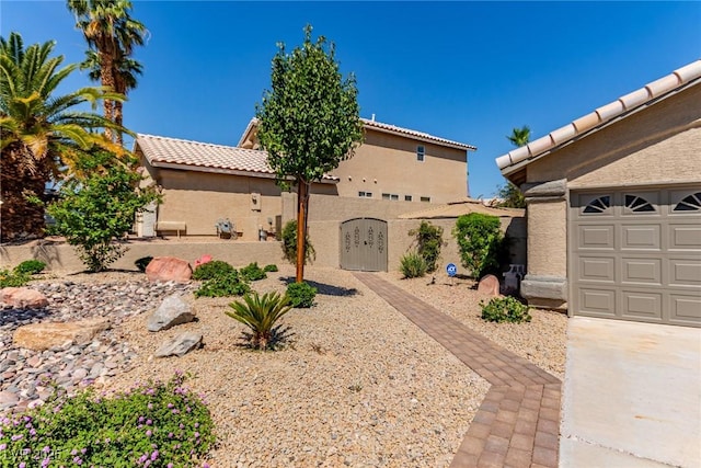 1761 Summerwood Cir, Henderson, NV 89012 - view of front facade with a tiled roof, stucco siding, and a gate