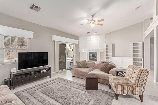 1761 Summerwood Cir, Henderson, NV 89012 - living room featuring ceiling fan, a large fireplace, and light wood-style floors