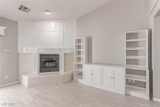 1761 Summerwood Cir, Henderson, NV 89012 - unfurnished living room featuring a glass covered fireplace and baseboards