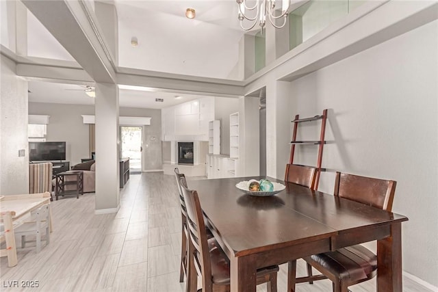 1761 Summerwood Cir, Henderson, NV 89012 - dining space featuring a ceiling fan, a fireplace, and a chandelier