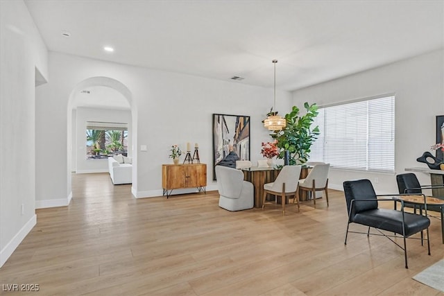 328 Hedgehope Dr, Las Vegas, NV 89183 - dining area featuring light wood-style flooring, arched walkways, and recessed lighting