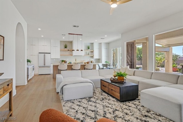 328 Hedgehope Dr, Las Vegas, NV 89183 - living area featuring plenty of natural light, a ceiling fan, light wood-style flooring, recessed lighting, and arched walkways