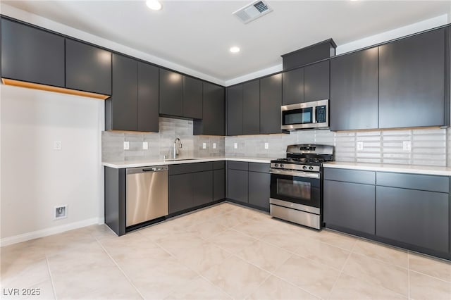 1801 Flycatch St, Las Vegas, NV 89138 - kitchen with appliances with stainless steel finishes, light countertops, backsplash, recessed lighting, and dark cabinets