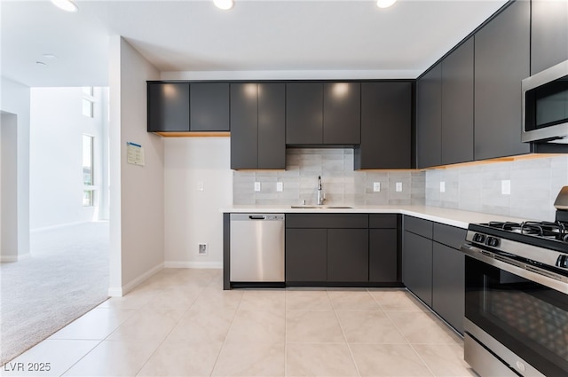 1801 Flycatch St, Las Vegas, NV 89138 - kitchen with appliances with stainless steel finishes, light countertops, decorative backsplash, recessed lighting, and light carpet