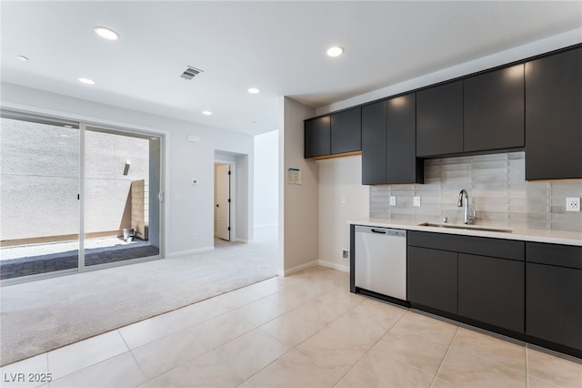 1801 Flycatch St, Las Vegas, NV 89138 - kitchen featuring stainless steel dishwasher, light carpet, light countertops, dark cabinets, and backsplash