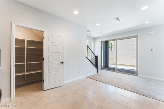 1801 Flycatch St, Las Vegas, NV 89138 - spare room with light colored carpet, recessed lighting, stairs, and light tile patterned floors