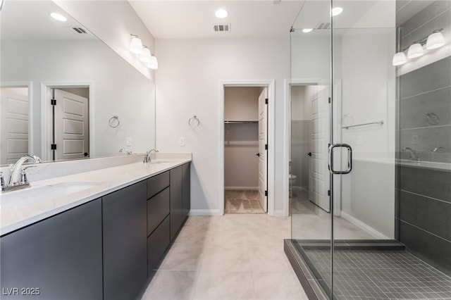 1801 Flycatch St, Las Vegas, NV 89138 - full bath featuring double vanity, a stall shower, recessed lighting, tile patterned floors, and a walk in closet