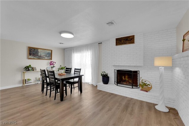 3509 Navajo Way, Las Vegas, NV 89108 - dining room with wood finished floors and a brick fireplace