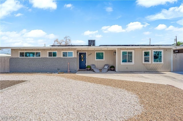 3509 Navajo Way, Las Vegas, NV 89108 - view of front of home featuring solar panels, a patio, and brick siding