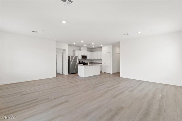 2721 Avril Point St, Las Vegas, NV 89156 - unfurnished living room with recessed lighting and light wood-style flooring