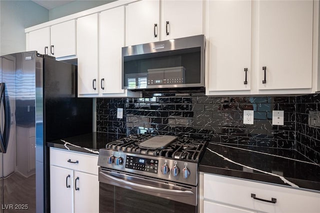 2545 Divine Sky Dr, Henderson, NV 89044 - kitchen with stainless steel appliances, dark countertops, white cabinets, and decorative backsplash
