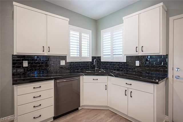 2545 Divine Sky Dr, Henderson, NV 89044 - kitchen with dishwasher, dark countertops, tasteful backsplash, white cabinetry, and light wood finished floors
