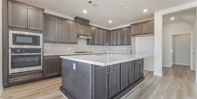 765 Cloud Creek St, Henderson, NV 89011 - kitchen with stainless steel appliances, light wood finished floors, light countertops, tasteful backsplash, and recessed lighting