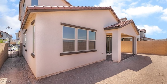765 Cloud Creek St, Henderson, NV 89011 - rear view of property with stucco siding, a tile roof, and a patio area
