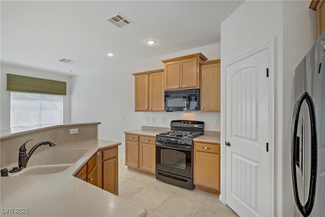 10062 Aspen Rose St Unit 103, Las Vegas, NV 89183 - kitchen with black appliances, light countertops, light tile patterned floors, recessed lighting, and light brown cabinets