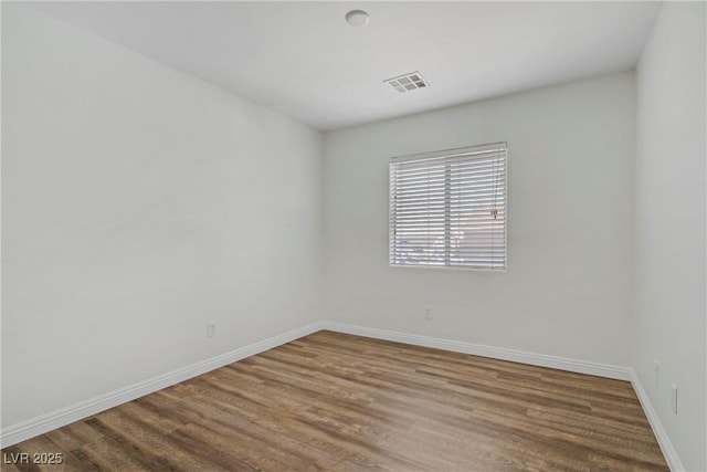 10062 Aspen Rose St Unit 103, Las Vegas, NV 89183 - unfurnished room with baseboards and wood finished floors