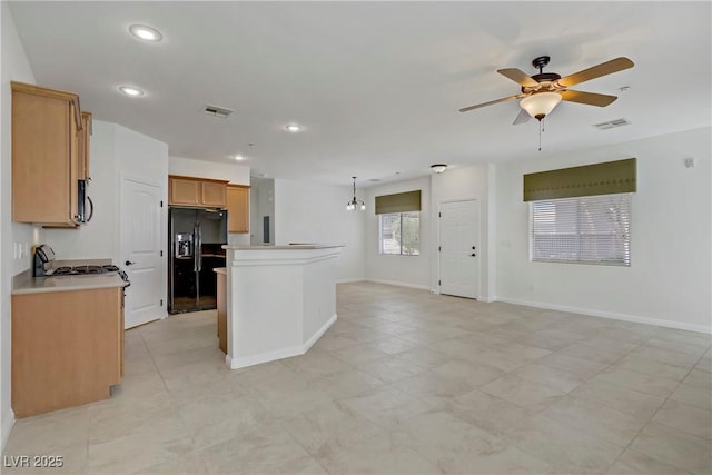 10062 Aspen Rose St Unit 103, Las Vegas, NV 89183 - kitchen with black fridge, ceiling fan, open floor plan, a center island, and recessed lighting