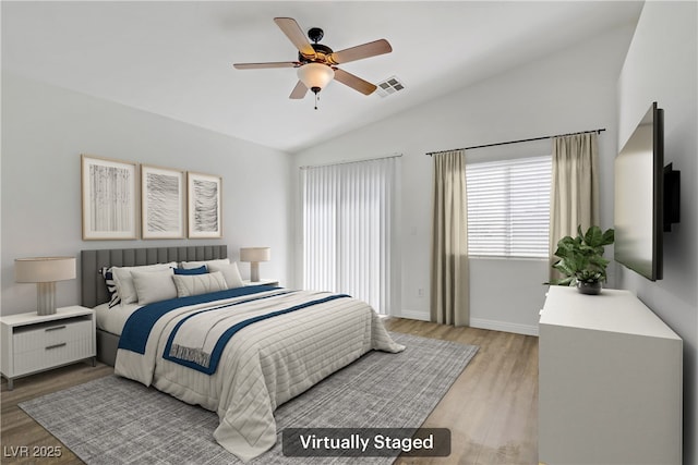 10062 Aspen Rose St Unit 103, Las Vegas, NV 89183 - bedroom featuring vaulted ceiling, light wood-type flooring, multiple windows, and a ceiling fan