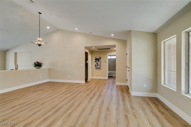 9800 Rosamond Dr, Las Vegas, NV 89134 - unfurnished living room featuring lofted ceiling, recessed lighting, light wood-style floors, and a chandelier