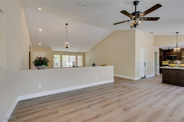 9800 Rosamond Dr, Las Vegas, NV 89134 - unfurnished living room with a chandelier, light wood-style floors, a ceiling fan, recessed lighting, and high vaulted ceiling