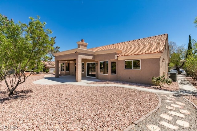 9800 Rosamond Dr, Las Vegas, NV 89134 - back of property featuring a chimney, stucco siding, a tile roof, and a patio