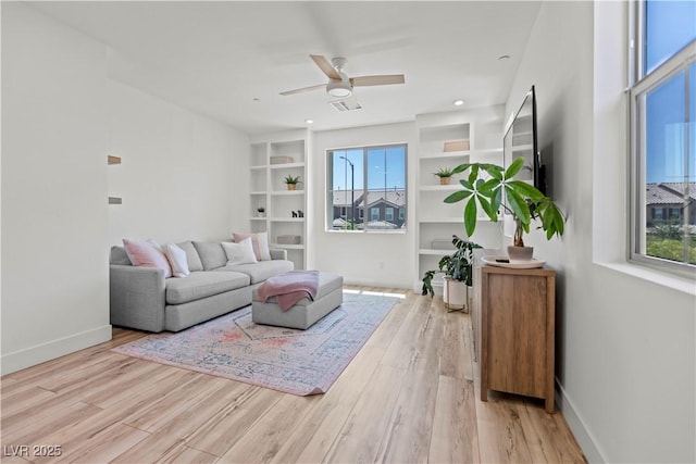 3369 Ponicelli Ln, Henderson, NV 89044 - living area featuring wood finished floors, ceiling fan, and built in features