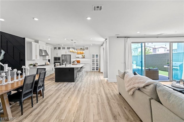 3369 Ponicelli Ln, Henderson, NV 89044 - living room with light wood-type flooring, recessed lighting, and a chandelier