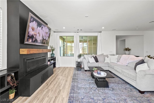 3369 Ponicelli Ln, Henderson, NV 89044 - living area with wood finished floors, a fireplace, and recessed lighting