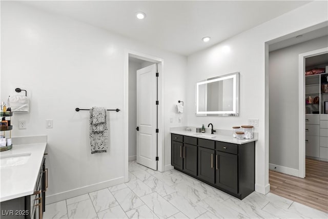 3369 Ponicelli Ln, Henderson, NV 89044 - bathroom with two vanities, marble look tile flooring, recessed lighting, and a spacious closet