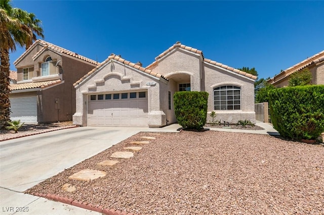 87 Ginger Lily Ter, Henderson, NV 89074 - mediterranean / spanish home with driveway, stucco siding, a tiled roof, and an attached garage