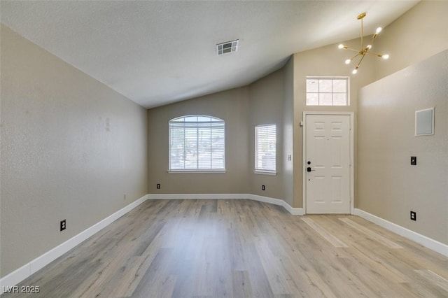 87 Ginger Lily Ter, Henderson, NV 89074 - entryway featuring a chandelier, plenty of natural light, light wood-style floors, and high vaulted ceiling