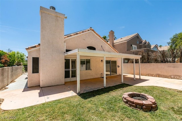 87 Ginger Lily Ter, Henderson, NV 89074 - back of house with a fire pit, a chimney, stucco siding, a patio area, and a tile roof