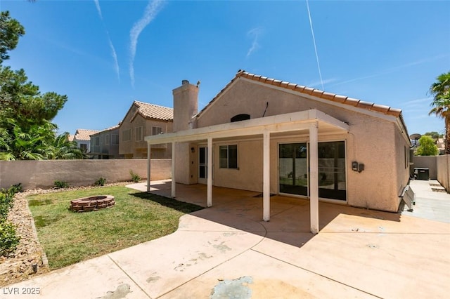 87 Ginger Lily Ter, Henderson, NV 89074 - back of house featuring a fire pit, stucco siding, a fenced backyard, a patio, and a chimney