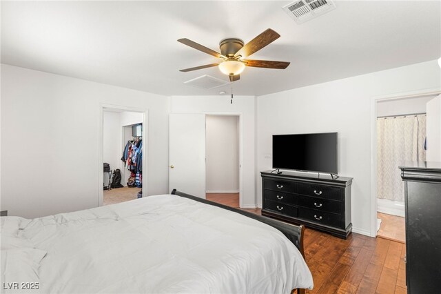 10253 Martinsburg Ct, Las Vegas, NV 89183 - bedroom featuring hardwood / wood-style floors, a ceiling fan, a walk in closet, a closet, and connected bathroom