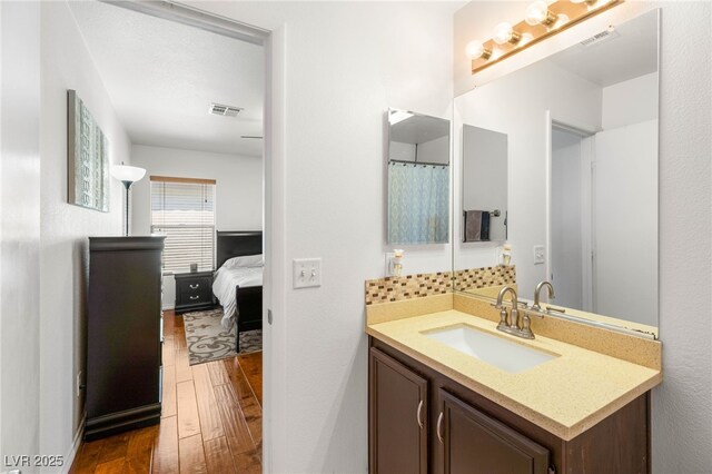 10253 Martinsburg Ct, Las Vegas, NV 89183 - ensuite bathroom featuring hardwood / wood-style floors and vanity