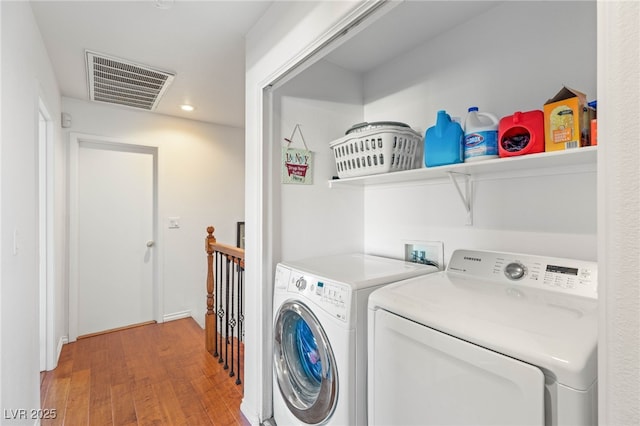 10253 Martinsburg Ct, Las Vegas, NV 89183 - laundry room featuring washer and clothes dryer, light wood finished floors, and recessed lighting