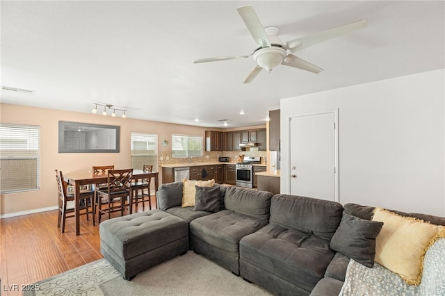 10253 Martinsburg Ct, Las Vegas, NV 89183 - living area with light wood-style floors and ceiling fan