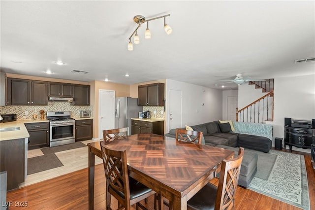 10253 Martinsburg Ct, Las Vegas, NV 89183 - dining room with light wood-type flooring, ceiling fan, stairway, and recessed lighting