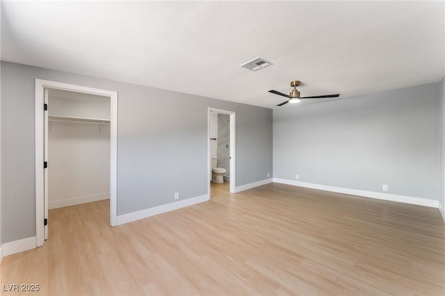 915 Melrose Dr, Las Vegas, NV 89101 - unfurnished bedroom with a walk in closet, light wood-style floors, a closet, ceiling fan, and ensuite bathroom