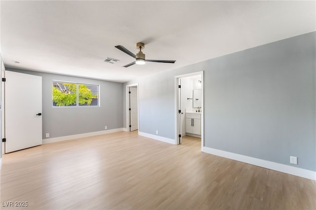 915 Melrose Dr, Las Vegas, NV 89101 - unfurnished bedroom with light wood-style floors, a ceiling fan, and connected bathroom
